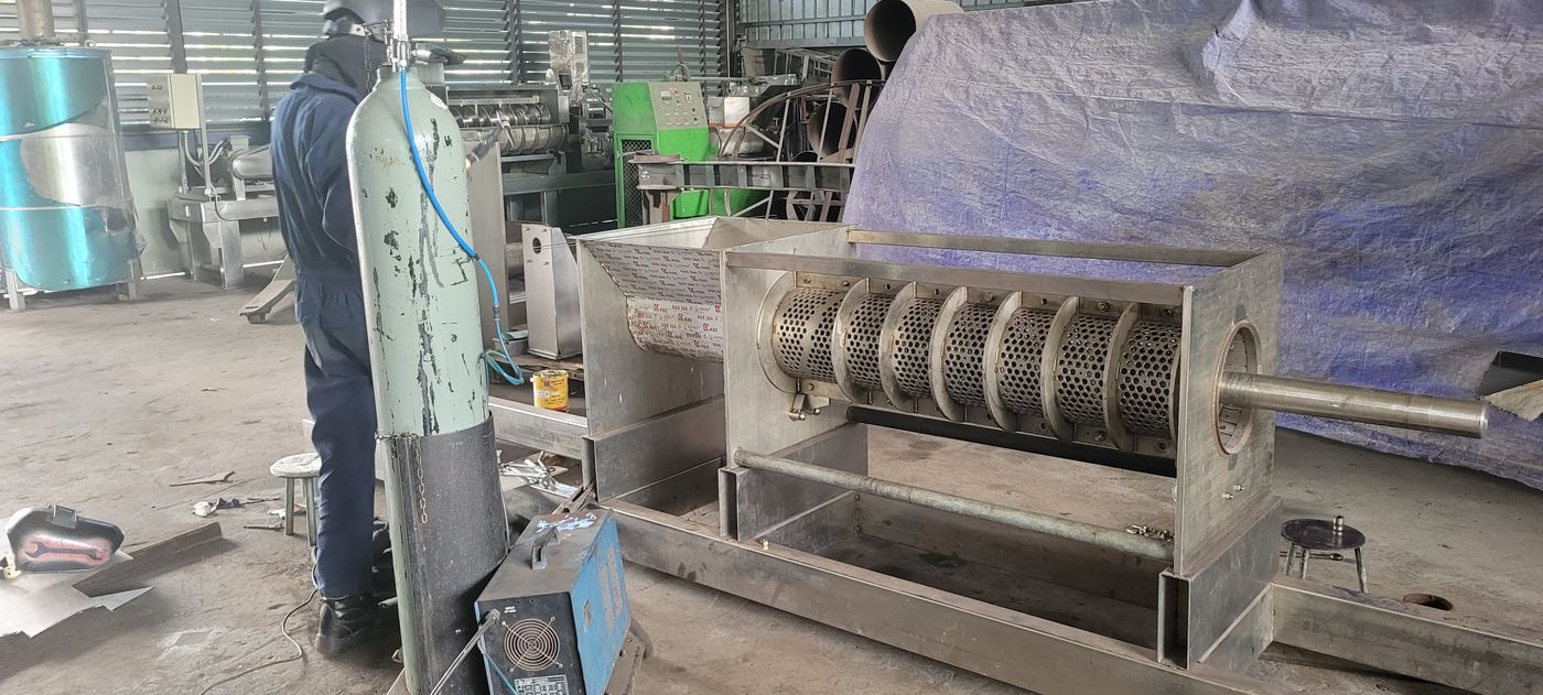 A stainless screw press for the coconut industry, being built